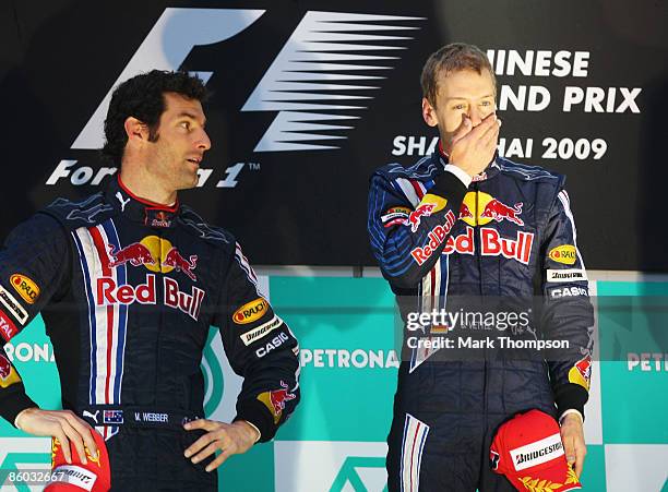 Race winner Sebastian Vettel of Germany and Red Bull Racing celebrates with second placed team mate Mark Webber of Australia and Red Bull Racing on...