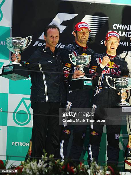 Race winner Sebastian Vettel of Germany and Red Bull Racing celebrates with second placed team mate Mark Webber of Australia and Red Bull Racing and...