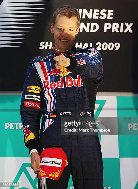 Sebastian Vettel of Germany and Red Bull Racing celebrates on the podium after the Chinese Formula One Grand Prix at the Shanghai International...