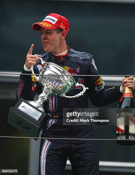 Second placed Mark Webber of Australia and Red Bull Racing celebrates on the podium after the Chinese Formula One Grand Prix at the Shanghai...