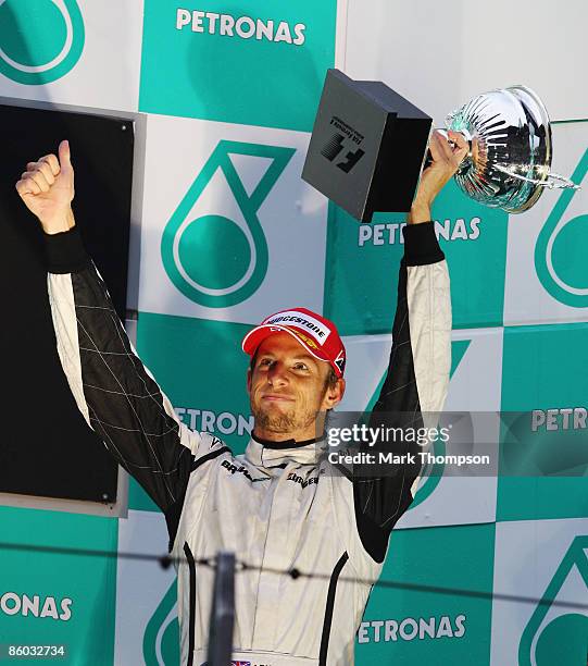 Third placed Jenson Button of Great Britain and Brawn GP celebrates on the podium after the Chinese Formula One Grand Prix at the Shanghai...