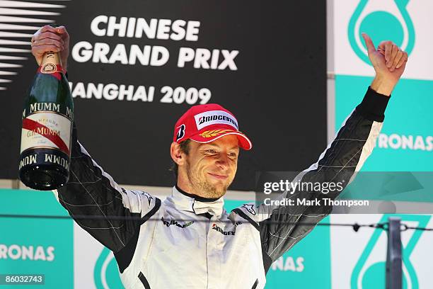 Third placed Jenson Button of Great Britain and Brawn GP celebrates on the podium after the Chinese Formula One Grand Prix at the Shanghai...