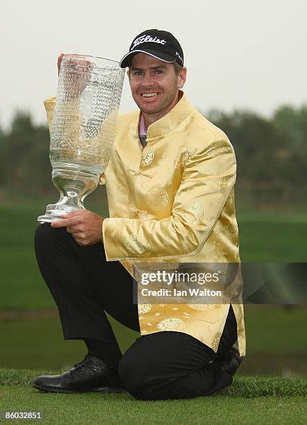 Scott Strange of Australia celebrates with the trophy after winning the final round of the Volvo China Open at the Beijing CBD International Golf...