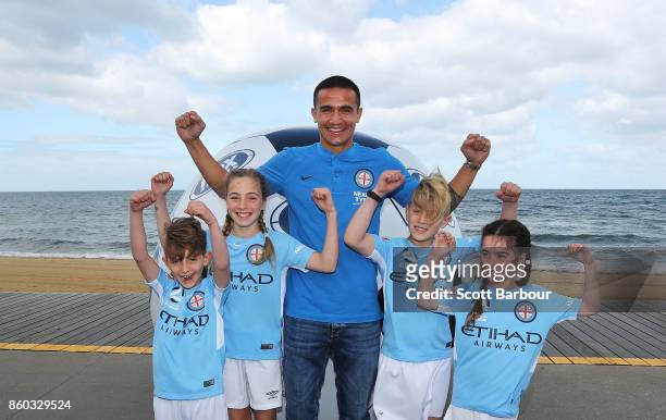 Melbourne City player Tim Cahill poses with kids from Melbourne City junior affiliate clubs during a Melbourne A-League Derby Media Opportunity on St...