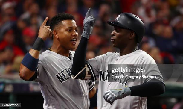 Didi Gregorius of the New York Yankees celebrates his two-run homerun with Starlin Castro in the third inning against the Cleveland Indians in game...