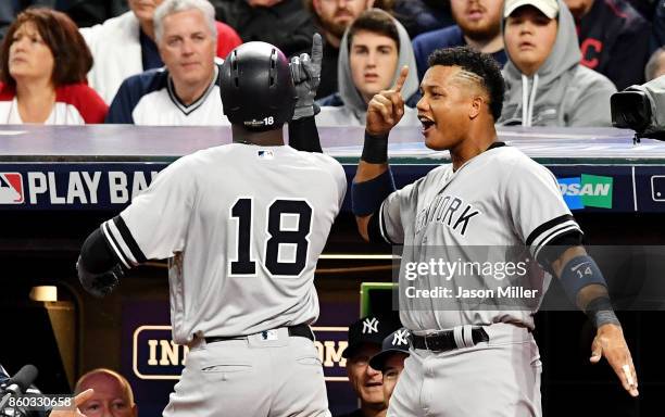 Didi Gregorius of the New York Yankees celebrates his two-run homerun with Starlin Castro in the third inning against the Cleveland Indians in game...