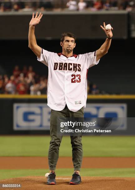 Olympian Michael Phelps throws out the first pitch before the National League Divisional Series game three between the Arizona Diamondbacks and the...