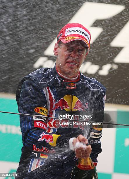 Sebastian Vettel of Germany and Red Bull Racing celebrates on the podium after winning the Chinese Formula One Grand Prix at the Shanghai...