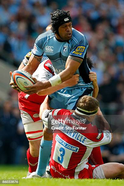 Ma'ama Molitika of Cardiff looks to offload as he is tackled by Greg Somerville of Gloucester during the EDF Energy Cup Final between Gloucester and...