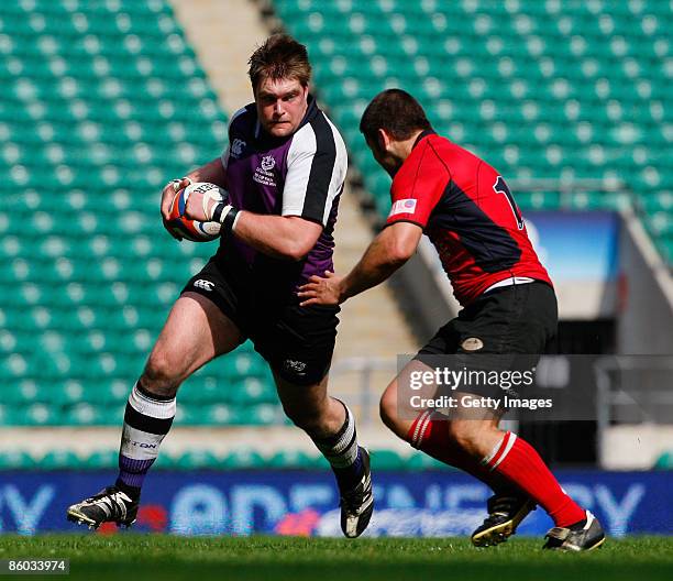 Leo Glass of Clifton is challenged by Jean Botha of Hartpury during the EDF Energy Intermediate Cup Final between Hartpury College and Clifton at...