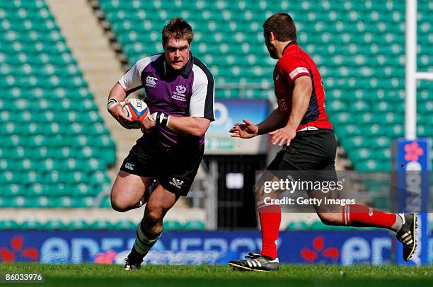 Leo Glass of Clifton is challenged by Jean Botha of Hartpury during the EDF Energy Intermediate Cup Final between Hartpury College and Clifton at...