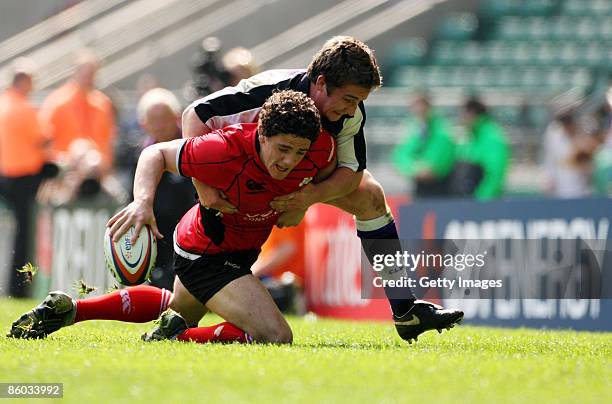 Paul Jarvis of Hartpury is tackled by Ollie Sills of Clifton during the EDF Energy Intermediate Cup Final between Hartpury College and Clifton at...