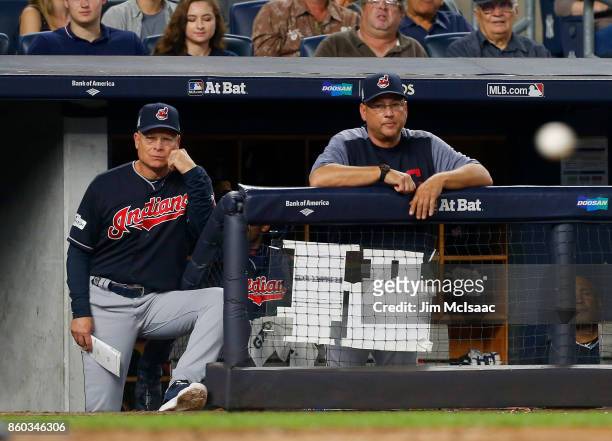 Bench coach Brad Mills and manager Terry Francona of the Cleveland Indians look on against the New York Yankees in Game Three of the American League...