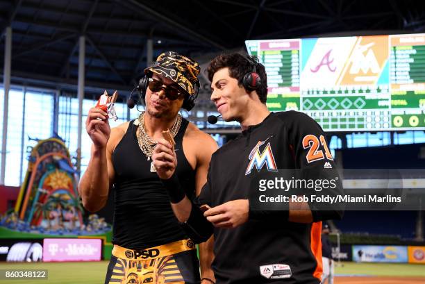 Giancarlo Stanton and Christian Yelich of the Miami Marlins eat KitKat bars while being interviewed for the MLB Network show Intentional Talk before...