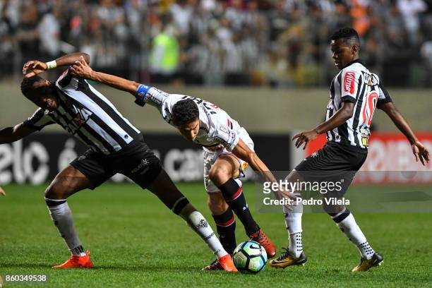 Roger Bernardo and Cazares of Atletico MG and Hernanes of Sao Paulo battle for the ball during a match between Atletico MG and Sao Paulo as part of...