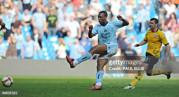 Manchester City's English forward Daniel Sturridge scores his team's fourth goal against West Bromwich Albion at The City of Manchester Stadium in...