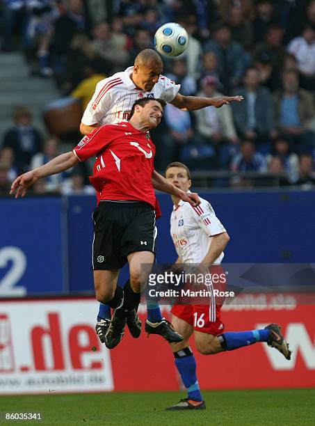 Alex Silva of Hamburg and Sergio Pinto of Hannover jump for a header during the Bundesliga match between Hamburger SV and Hannover 96 at the HSH...