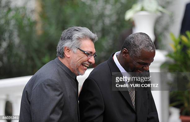 The President of Paraguay Fernando Lugo shares a laugh with the Chief of Protocol of Trinidad and Tobago, on his arrival for a retreat for heads of...