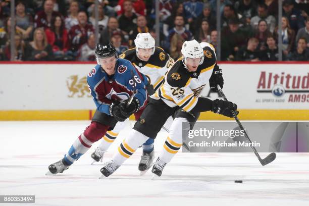 Riley Nash of the Boston Bruins skates against Mikko Rantanen of the Colorado Avalanche at the Pepsi Center on October 11, 2017 in Denver, Colorado.