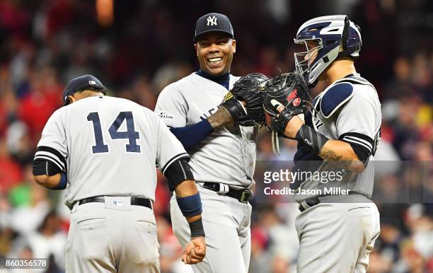 Aroldis Chapman, Starlin Castro and Gary Sanchez of the New York Yankees celebrate in the ninth inning against the Cleveland Indians in Game Five of...