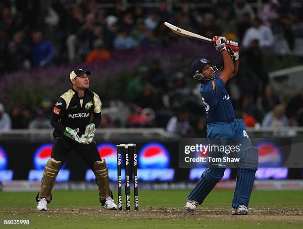 Rohit Sharma of Deccan Chargers hits out at Brendon McCullum of Kolkata looks on during the IPL T20 match between Deccan Chargers and Kolkata Knight...