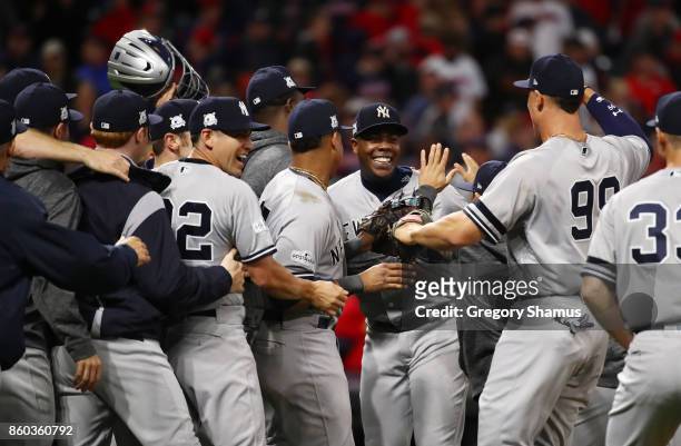 Aroldis Chapman of the New York Yankees celebrates with teammates after their 5 to 2 win over the Cleveland Indians in Game Five of the American...
