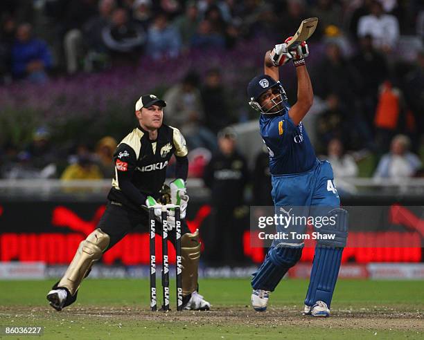 Rohit Sharma of Deccan Chargers hits out at Brendon McCullum of Kolkata looks on during the IPL T20 match between Deccan Chargers and Kolkata Knight...