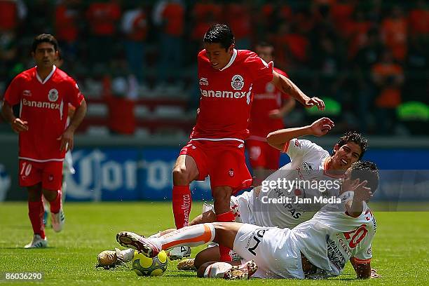 Mario Mendez of Toluca vies for the ball with Alan Zamora and Jesus Chavez of Jaguares during their match in the 2009 Clausura tournament, the...