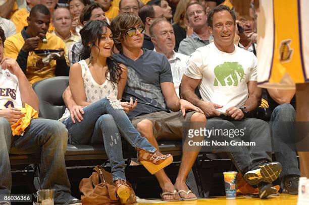 Actress Vanessa Hudgens, Actor Zac Efron, and Harvey Levin of TMZ watch a game from courtside between the Utah Jazz and the Los Angeles Lakers in...