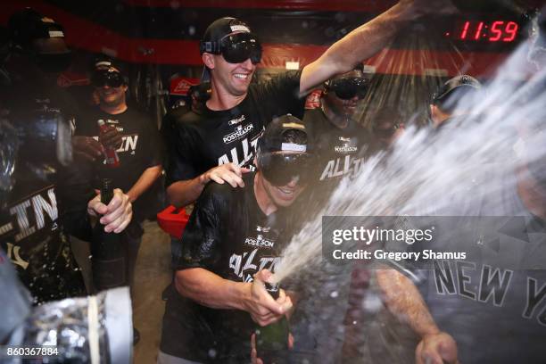 The New York Yankees celebrate in the locker room after their 5 to 2 win over the Cleveland Indians in Game Five of the American League Divisional...