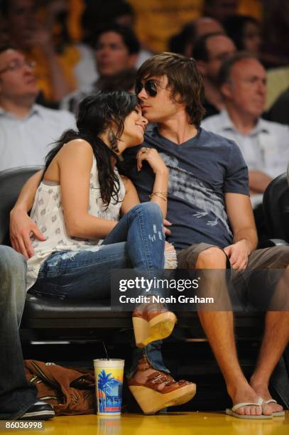 Actress Vanessa Hudgens and Zac Efron watch a game from courtside between the Utah Jazz and the Los Angeles Lakers in Game One of the Western...