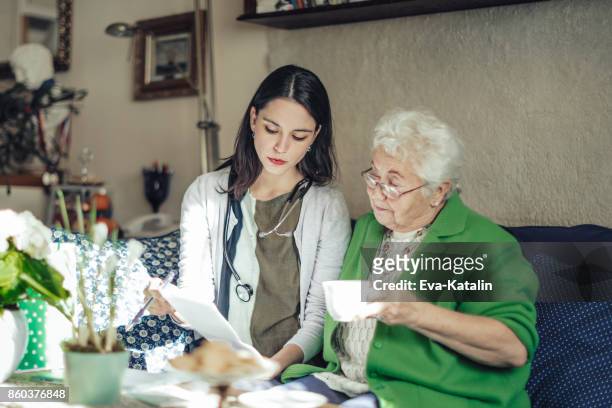 Social worker is visiting a senior woman