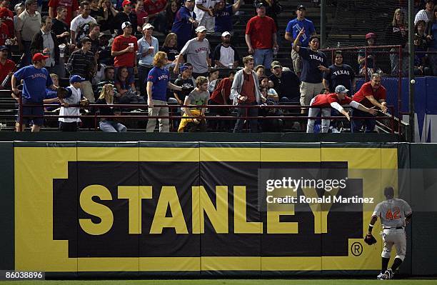 Centerfielder Adam Jones of the Baltimore Orioles goes to the wall on a hit triple by Ian Kinsler while wearing jersey to commemorate Jackie Robinson...