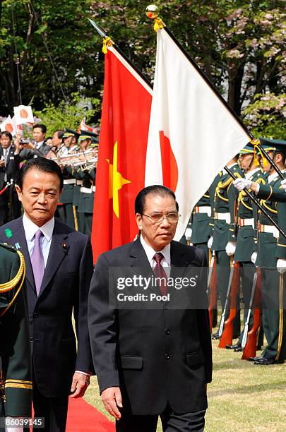 Vietnamese Communist Party General Secretary Nong Duc Manh reviews a guard of honour accompanied by Japanese Prime Minister Taro Aso during a...