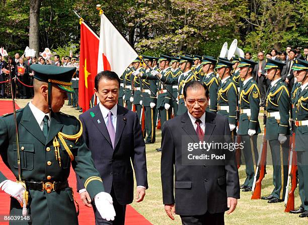 Vietnamese Communist Party General Secretary Nong Duc Manh reviews a guard of honour accompanied by Japanese Prime Minister Taro Aso during a...