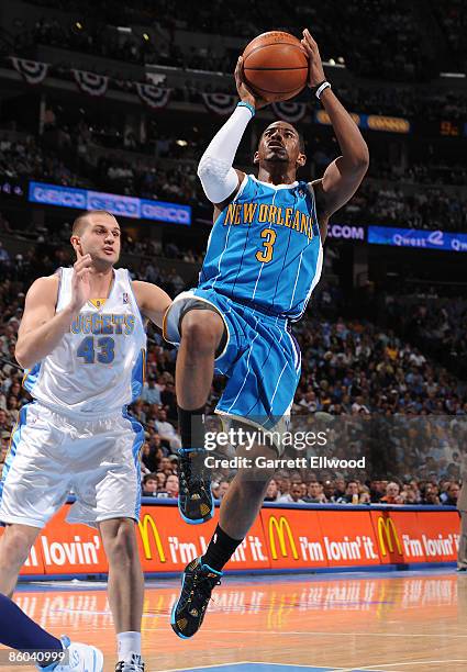 Chris Paul of the New Orleans Hornets goes to the basket against Linas Kleiza of the Denver Nuggets during Game One of the Western Conference...