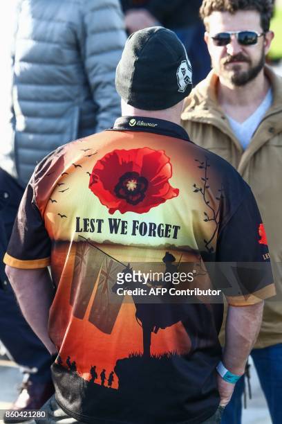 Man wears a jersey showing New Zealand's flag and remembering the dead with the expression "Lest We Forget" during the commemoration of the WWI...