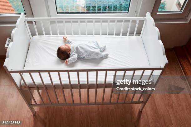 sleeping baby girl - baby cot stock pictures, royalty-free photos & images