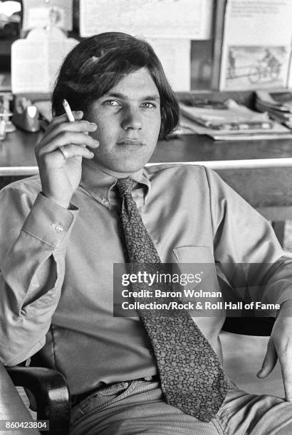 Portrait of Jann Wenner, founder and publisher of Rolling Stone magazine, smoking, in the magazine's original offices on Brannan St in San Francisco,...
