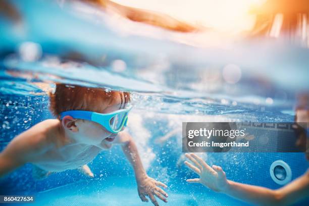 happy kids playing tag underwater - tag 11 stock pictures, royalty-free photos & images