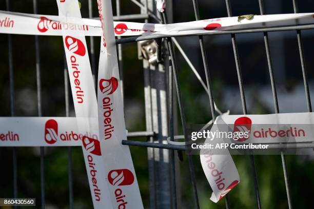 Fence is fixed with a tape labelled with the logo of German airline Air Berlin in Berlin on October 12, 2017. Germany's biggest airline Lufthansa...