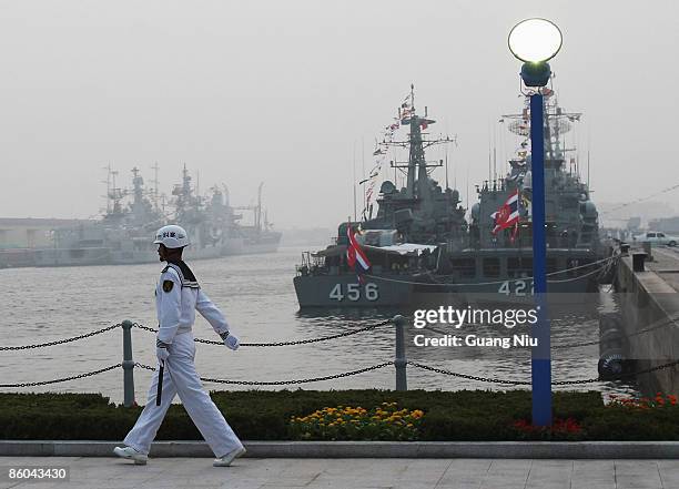 Chinese naval soldier gaurds in front of foreign warships at Qingdao Port on April 20, 2009 in Qingdao of Shandong Province, China. China's navy is...