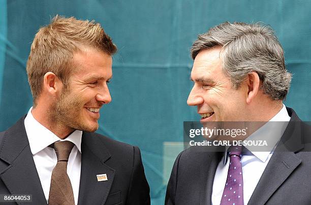 English football player David Beckham and British Prime Minister Gordon Brown pose for pictures outside 10 Downing Street, in London on April 20,...