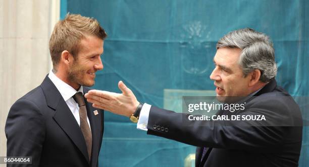 English football player David Beckham and British Prime Minister Gordon Brown pose for pictures outside 10 Downing Street, in London on April 20,...