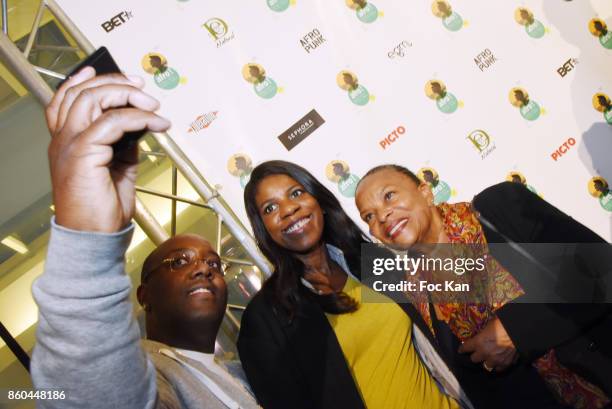 Minister Christiane Taubira poses with fans for a selfie during the "Afro" Rokhaya Diallo and photographer Brigitte Sombie Exhibition at Maison des...