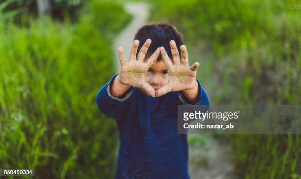 kid showing hand dirty with sand. - new zealand farmer stock pictures, royalty-free photos & images