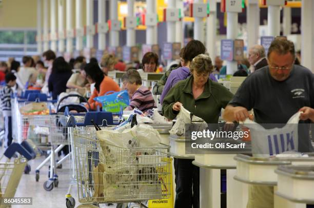 Shoppers queue to pay for their shopping in the Tesco Extra superstore on April 20, 2009 in New Malden, Surrey, England. The huge New Malden store...