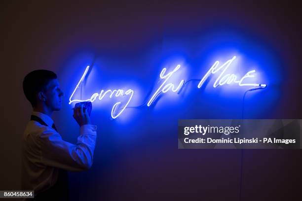 Sotheby's employee dusts 'Loving You More' by Tracey Emin, valued at &pound;25,000 to &pound;35 during a press preview for the forthcoming Art for...