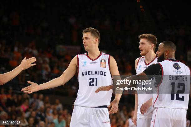 Daniel Johnson of the 36ers celebrates with team mates during the round two NBL match between the Cairns Taipans and the Adelaide 36ers at Cairns...