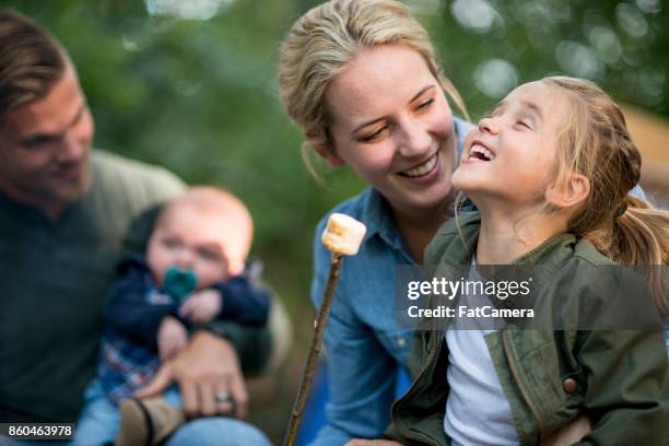 eating marshmallows - young family outside stock pictures, royalty-free photos & images